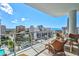 Balcony view showcasing city skyline, ocean views and a beautiful in-ground pool at 111 S Pineapple Ave # 1014, Sarasota, FL 34236