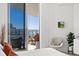 Relaxing main bedroom featuring a balcony with seating and views of the ocean at 111 S Pineapple Ave # 1014, Sarasota, FL 34236