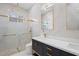 Elegant bathroom featuring glass shower, marble countertop, and modern fixtures at 115 Solana St, North Port, FL 34287