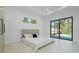 Minimalist bedroom featuring large sliding glass doors leading to an outdoor pool area at 115 Solana St, North Port, FL 34287