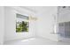 Bright bedroom with a large window and modern lighting fixtures at 115 Solana St, North Port, FL 34287