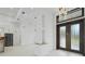 Spacious foyer with chandelier and views of the kitchen with stainless steel appliances at 115 Solana St, North Port, FL 34287