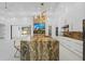 Bright modern kitchen with stainless steel appliances, a large island, and white cabinets with barstool seating at 115 Solana St, North Port, FL 34287