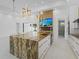 Open-concept kitchen with a large island, modern lighting, and high-end finishes at 115 Solana St, North Port, FL 34287