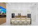 Bright modern kitchen with stainless steel appliances, a large island, and white cabinets at 115 Solana St, North Port, FL 34287
