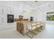 Bright modern kitchen with stainless steel appliances, a large island, and white cabinets at 115 Solana St, North Port, FL 34287
