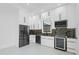 Well-lit kitchen with stainless steel fridge and modern appliances at 115 Solana St, North Port, FL 34287