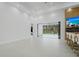 Bright living room with bar seating, a fireplace, and sliding doors leading to the screened-in pool area at 115 Solana St, North Port, FL 34287