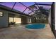 Inviting screened-in pool area with travertine tile and covered patio at 115 Solana St, North Port, FL 34287