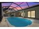 Inviting screened-in pool features a water feature with an expansive patio and outdoor lounging area at 115 Solana St, North Port, FL 34287