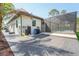 Screened in pool with modern tiling and water feature next to the back of the home at 115 Solana St, North Port, FL 34287