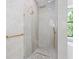 Elegant shower with glass enclosure, rain shower head and pebble floor, next to an adjacent soaking tub and window at 115 Solana St, North Port, FL 34287