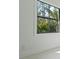 Bright wall and window with black trim looking out onto lush landscaping at 115 Solana St, North Port, FL 34287