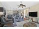 Bright living room with hardwood flooring, with kitchen, and a spiral staircase visible at 123 Faubel St, Sarasota, FL 34242