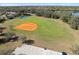 An aerial view of a well-maintained community baseball field with a parking lot nearby at 12736 Penguin Dr, Bradenton, FL 34212