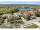The aerial view showcases the home's proximity to a serene lake, lush greenery, and well-maintained neighborhood at 12736 Penguin Dr, Bradenton, FL 34212