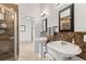 Bathroom featuring dual pedestal sinks, a walk-in shower, and tile flooring at 12736 Penguin Dr, Bradenton, FL 34212