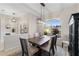 Elegant dining room with modern chandelier, and large windows with views of the landscaped yard at 12736 Penguin Dr, Bradenton, FL 34212