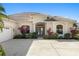 Charming single-story home featuring a tile roof, manicured landscaping, double door entry, and attached garage at 12736 Penguin Dr, Bradenton, FL 34212