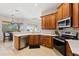 Modern kitchen with granite countertops, stainless steel appliances, and a seamless connection to the dining area at 12736 Penguin Dr, Bradenton, FL 34212