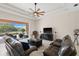 Bright living room with an expansive sliding glass door to the lanai and view of the backyard at 12736 Penguin Dr, Bradenton, FL 34212