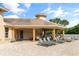 Community pool house and lounge area, complete with lounge chairs, ceiling fans, and outdoor seating at 12736 Penguin Dr, Bradenton, FL 34212