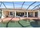 A beautiful screened-in pool and patio area with a built-in grill, seating, and plenty of space for entertaining at 12736 Penguin Dr, Bradenton, FL 34212