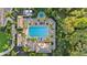 Overhead aerial view of community pool and hot tub surrounded by lounge chairs, cabanas and lush landscaping at 12803 Coastal Breeze Way, Bradenton, FL 34211