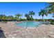 Resort-style pool with lounge seating, palm trees, and a spacious deck for relaxing and entertaining at 12803 Coastal Breeze Way, Bradenton, FL 34211