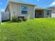 Spacious backyard featuring well-maintained lawn and exterior of home; ideal for outdoor relaxation and entertaining at 13393 Golden Lime Ave, Spring Hill, FL 34609
