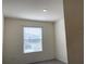 Bright bedroom with window and view to neighborhood at 13393 Golden Lime Ave, Spring Hill, FL 34609