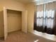 Bedroom features walk-in closet and large window with decorative curtains at 13393 Golden Lime Ave, Spring Hill, FL 34609