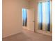 Neutral bedroom with carpet, window with curtains, and an open door to another room at 13393 Golden Lime Ave, Spring Hill, FL 34609