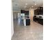 A spacious kitchen with dark cabinets, granite countertops, stainless appliances, and tile flooring at 13393 Golden Lime Ave, Spring Hill, FL 34609