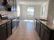 An open kitchen featuring dark cabinets, granite countertops, and stainless steel appliances at 13393 Golden Lime Ave, Spring Hill, FL 34609