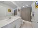 Modern bathroom with white cabinets, marble countertops, and a shower with a curtain at 13414 Sunset Sapphire Ct, Parrish, FL 34219