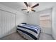 This simple bedroom includes a ceiling fan, closet space, and bright windows at 13414 Sunset Sapphire Ct, Parrish, FL 34219