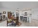 Bright kitchen and dining area with a kitchen island, stainless appliances, and a wood table at 13414 Sunset Sapphire Ct, Parrish, FL 34219
