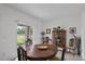 Cozy dining area features a rustic table, sliding glass door to patio, and decorative cabinet at 13414 Sunset Sapphire Ct, Parrish, FL 34219