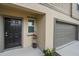 Close up of front door, address, and garage door on a two story home at 13414 Sunset Sapphire Ct, Parrish, FL 34219