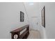 Hallway with high ceilings and tiled floors leads to a white interior door and stairs at 13414 Sunset Sapphire Ct, Parrish, FL 34219