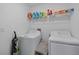 Bright laundry room features modern washer, dryer and storage space at 13414 Sunset Sapphire Ct, Parrish, FL 34219