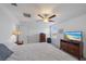 Cozy bedroom with a ceiling fan, a dresser, and a window with a view at 13414 Sunset Sapphire Ct, Parrish, FL 34219
