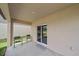 Cozy patio features seating, a sliding glass door to the home, and views of the grassy lawn at 13414 Sunset Sapphire Ct, Parrish, FL 34219