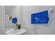 A sink with a decorative plant and a hand towel with 'FT. MYERS BEACH' add a personal touch to the powder room at 13414 Sunset Sapphire Ct, Parrish, FL 34219