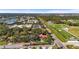 Aerial view of a neighborhood with a mix of residential homes, green spaces, and community facilities at 1354 Lucaya Ave, Venice, FL 34285