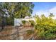 Backyard zen garden featuring a peaceful bench surrounded by lush greenery and stepping stones at 1354 Lucaya Ave, Venice, FL 34285