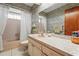 Bathroom featuring wallpaper, a large mirror, a vanity, and a tub and shower with a curtain at 1354 Lucaya Ave, Venice, FL 34285