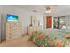 Bright bedroom features a dresser and sliding door to the screened patio at 1354 Lucaya Ave, Venice, FL 34285