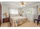 Bright bedroom with a ceiling fan, side tables, and windows providing natural light; features carpeted flooring at 1354 Lucaya Ave, Venice, FL 34285